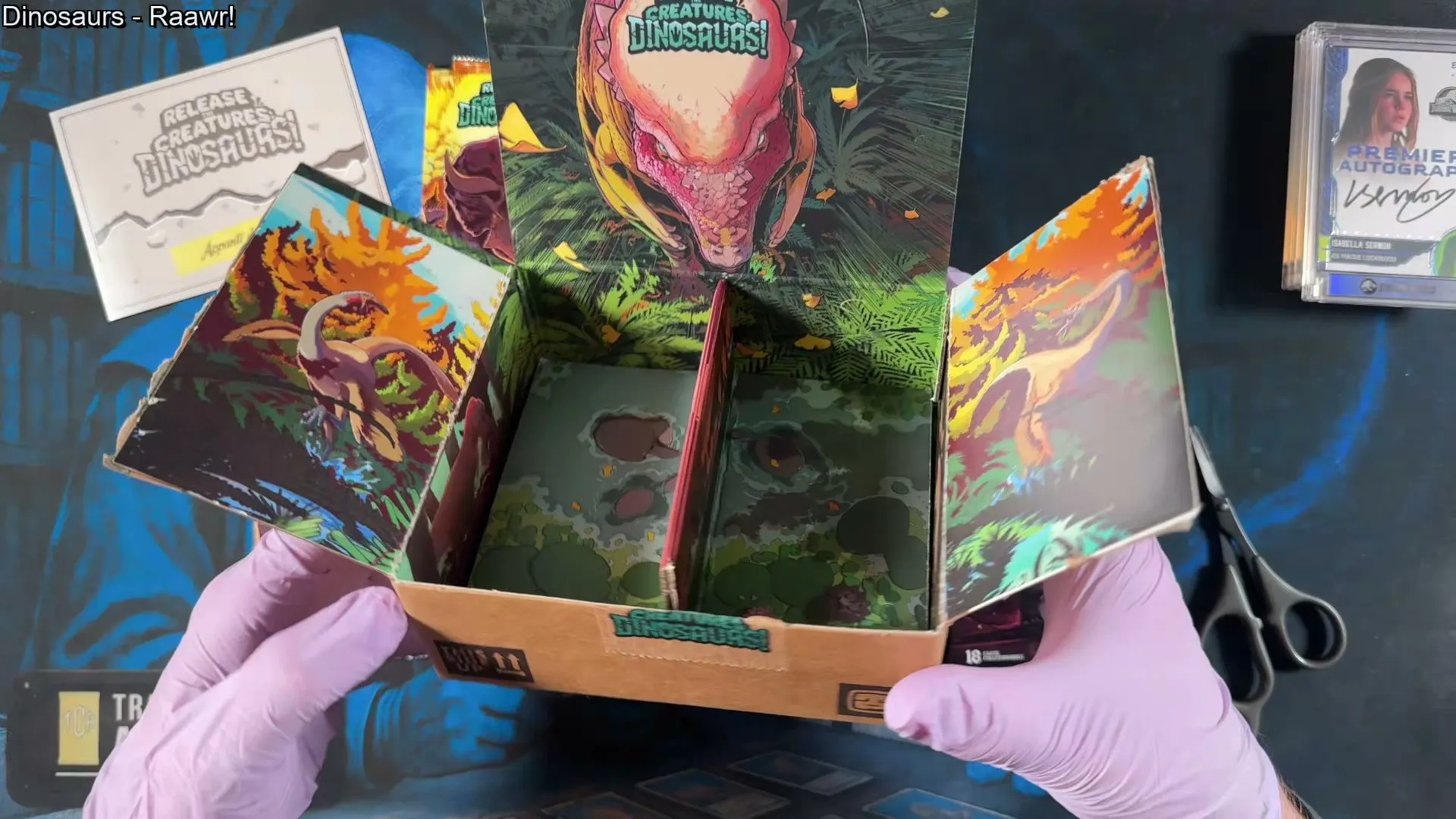 The Release the Creatures box opened out, every interior panel illustrated with painted dinosaur scenes