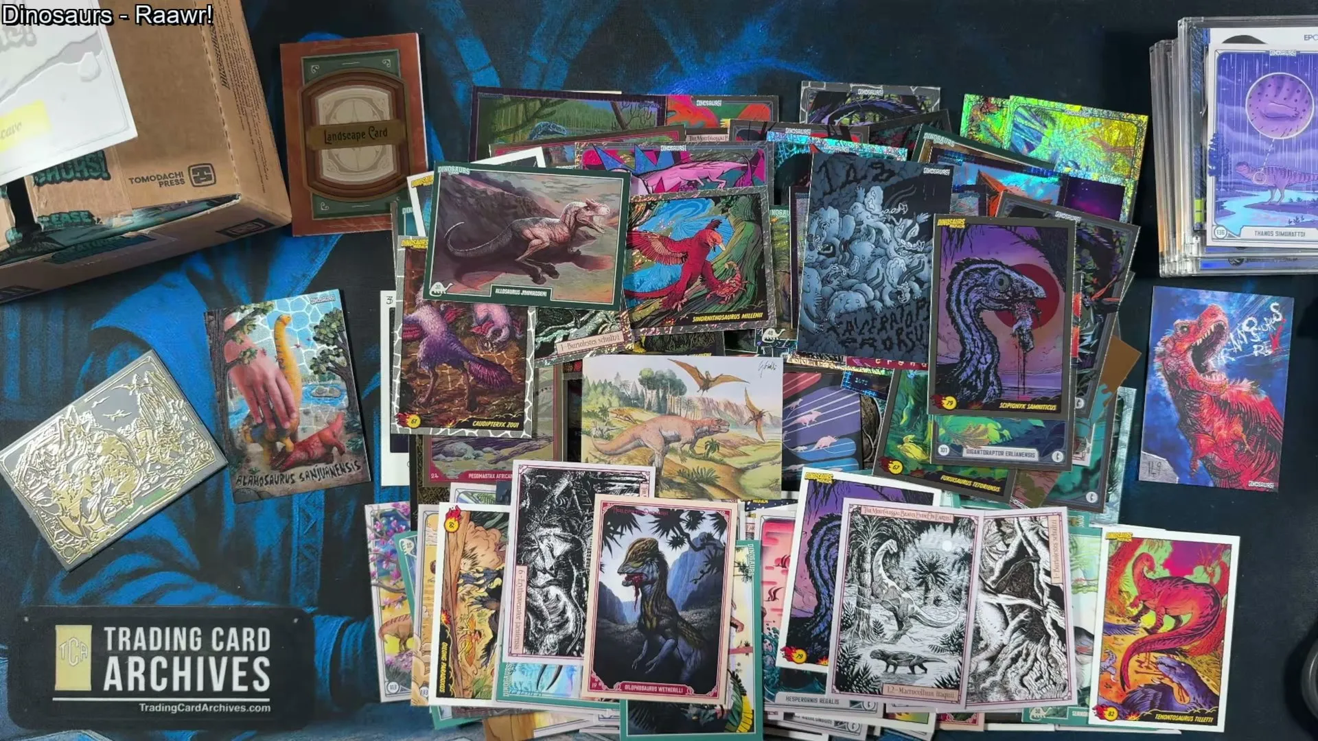 The full haul from one box of Release the Creatures: Dinosaurs spread across the table