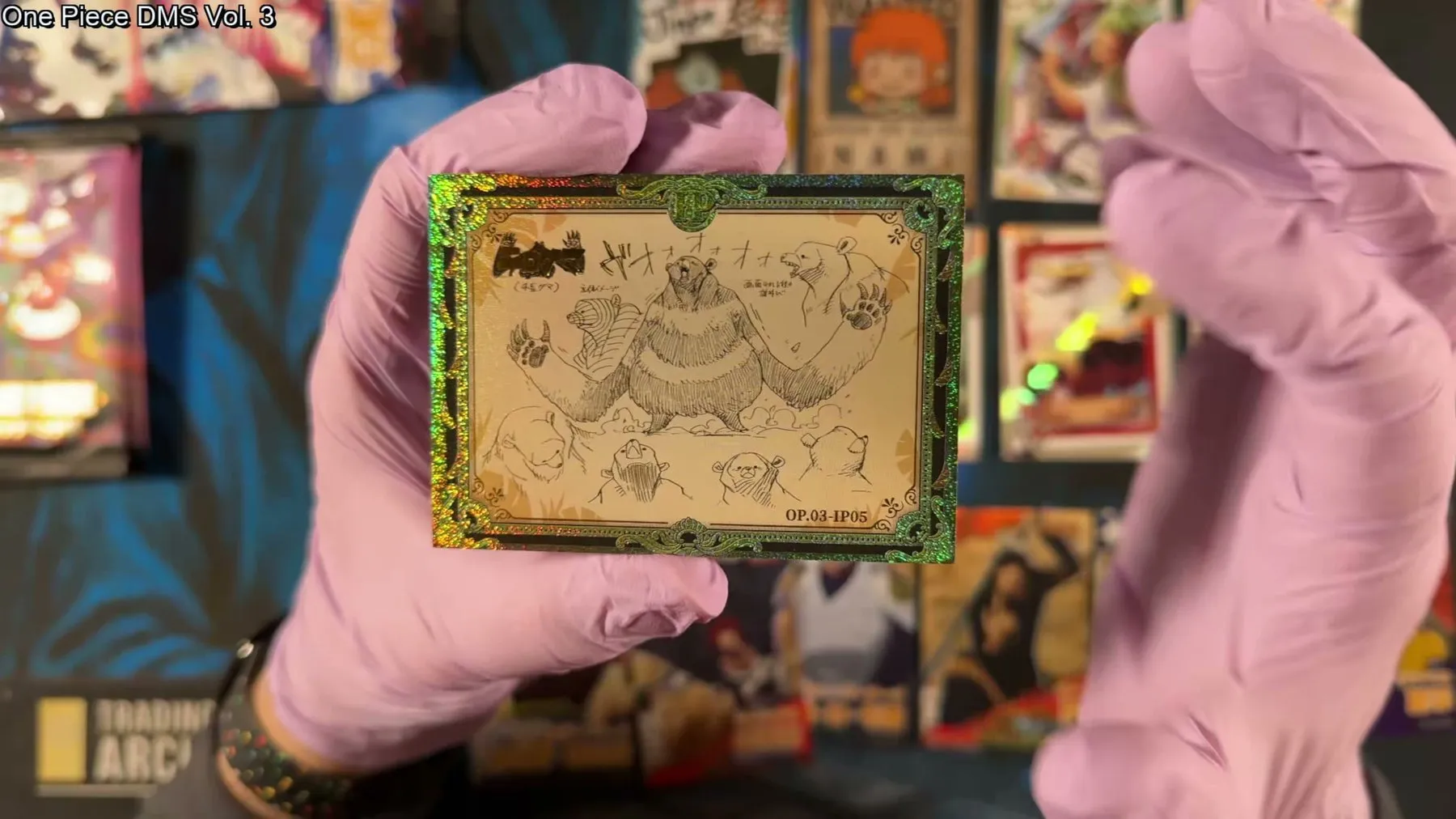 The gold-framed IP sketch card of Bartholomew Kuma from One Piece DMS Vol. 3, showing the artist's design sketches in a green and gold glitter border.